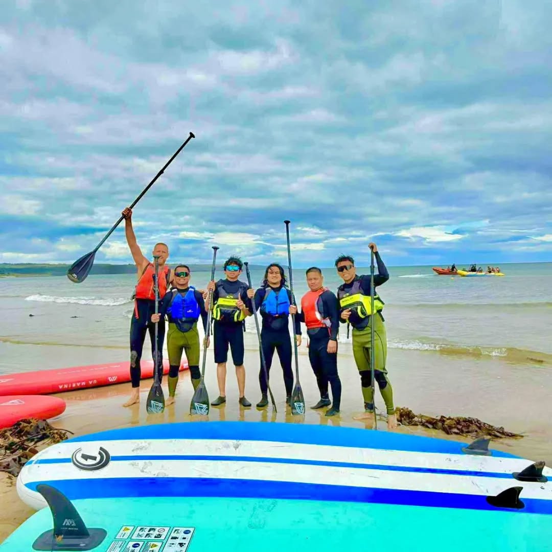 Paddleboarding group on the beach at Ardmore